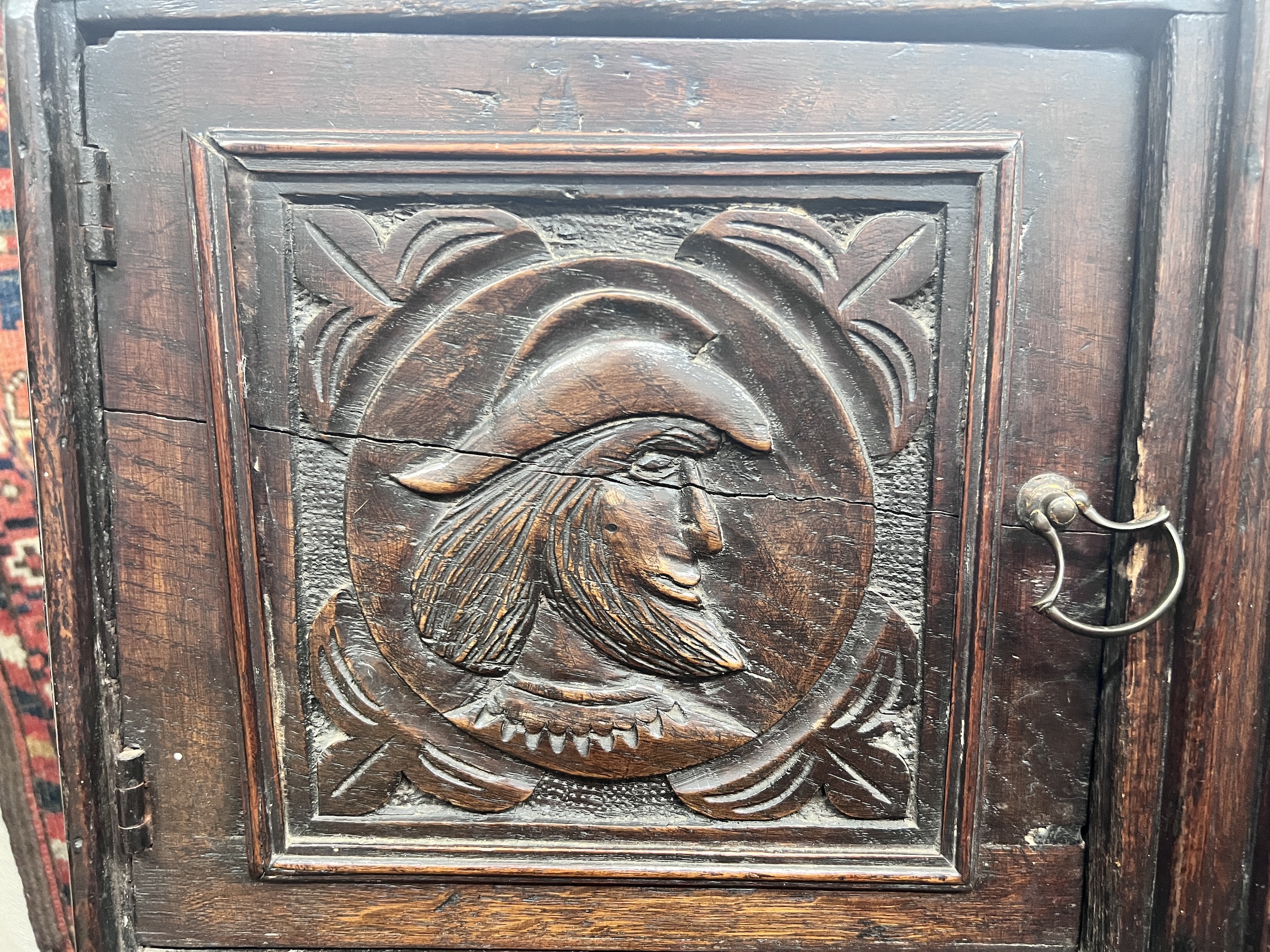 An 18th century style Flemish carved oak side cabinet, width 80cm, depth 62cm, height 165cm